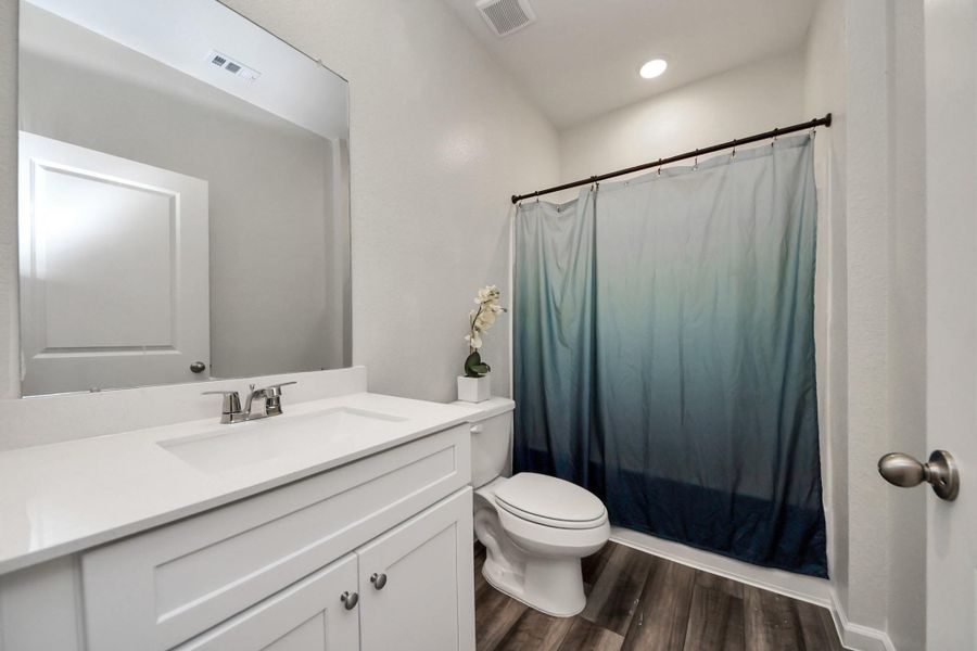 A secondary bath with cohesive cabinetry.