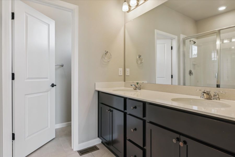 A bathroom with a large mirror.