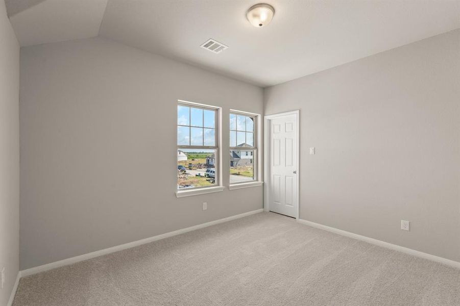 Your secondary bedroom features plush carpet, fresh paint, closet, and a large window that lets in plenty of natural lighting.