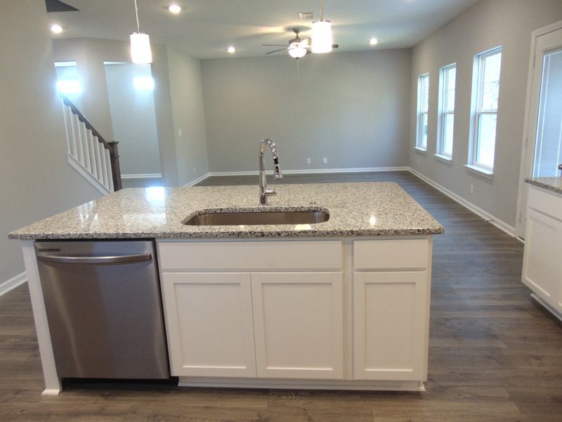 The kitchen where you can cook all your specialty dishes with love. This kitchen has under cabinet lights, included steel appliances, as well as a modern and large island and sink. The kitchen where you can cook all your specialty dishes with love. This kitchen has under cabinet lights, included steel appliances, as well as a modern and large island and sink.