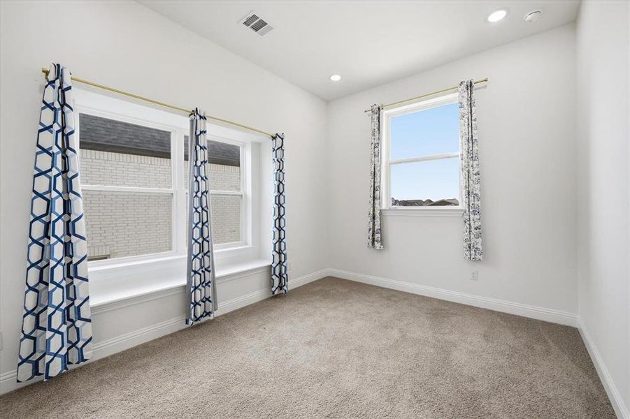Bright interior space featuring recessed lighting and two windows