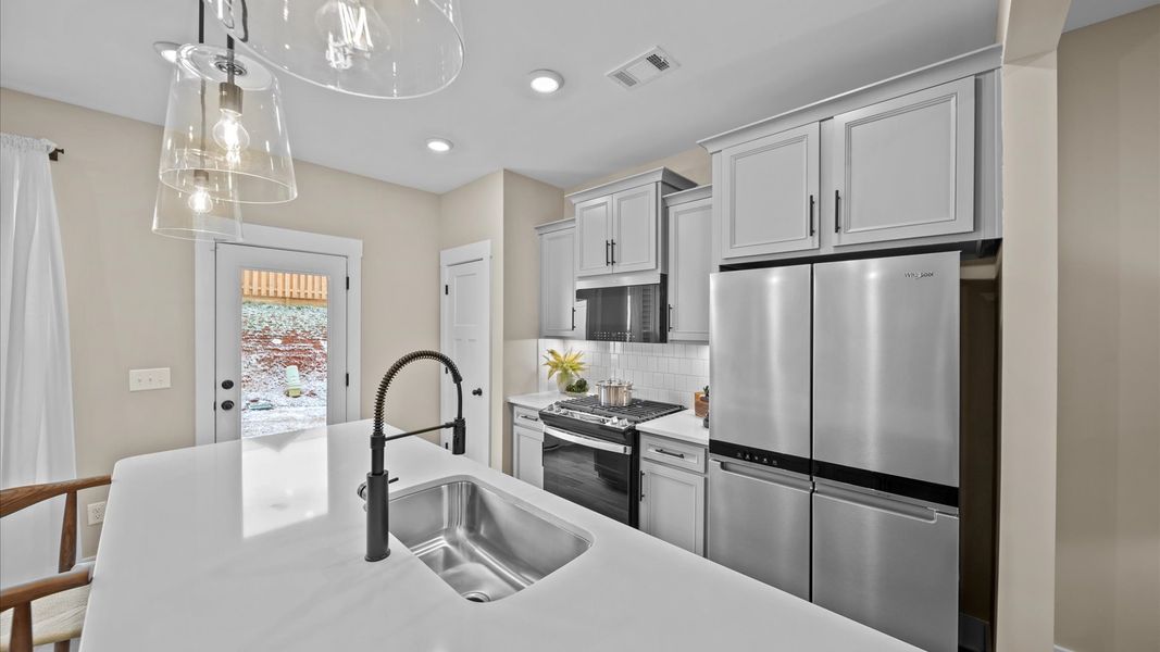 Accomplished layout with a stunning 9-foot island, pendant lighting, and superior craftsmanship