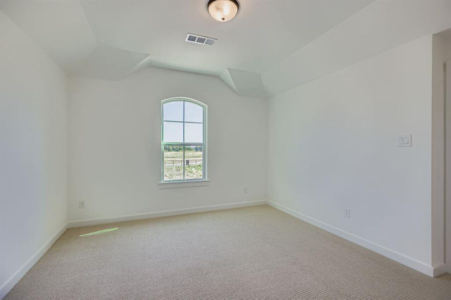Spare room featuring light carpet and baseboards