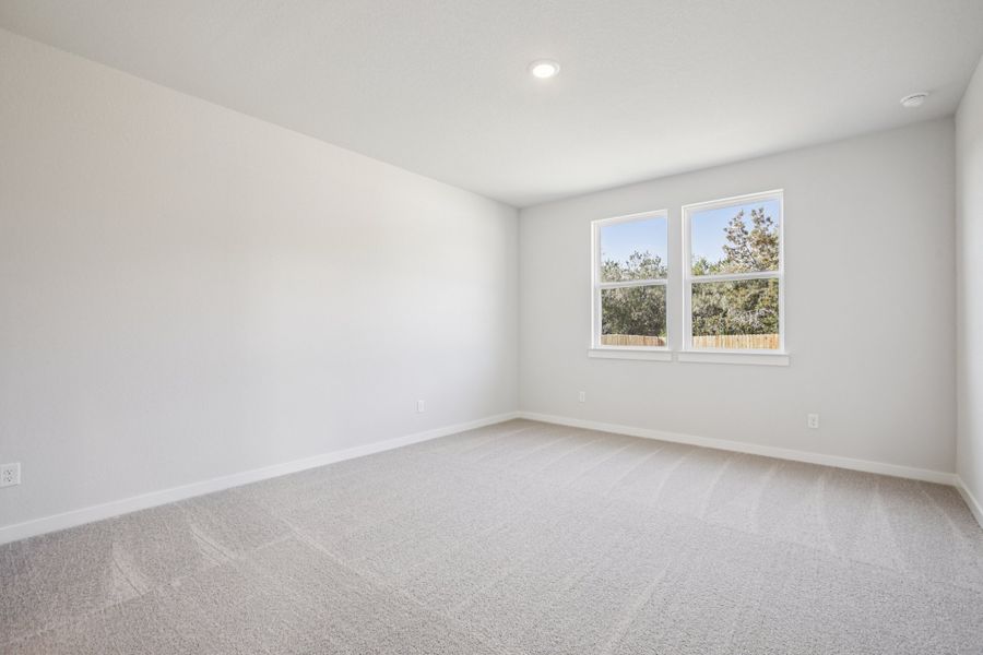 A room with a window and a white wall.