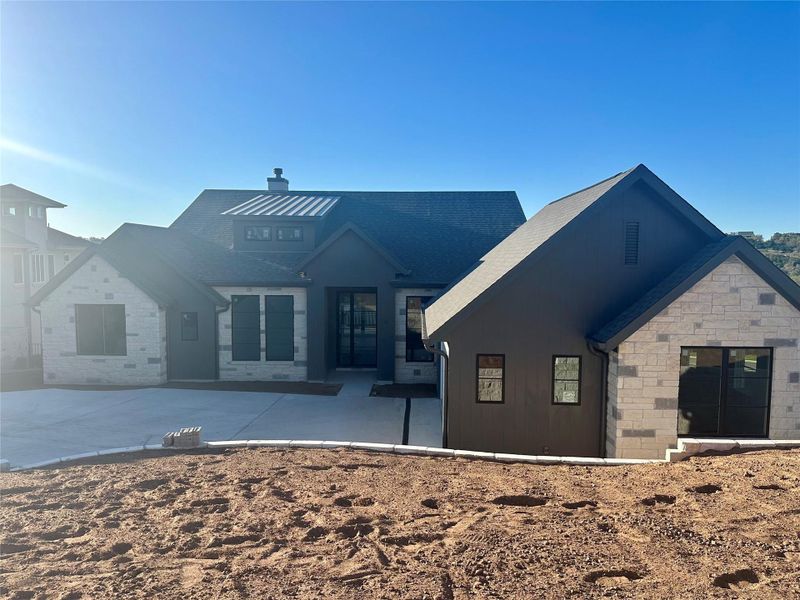 View of front of house featuring stone siding and a chimney View of front of house featuring stone siding and a chimney