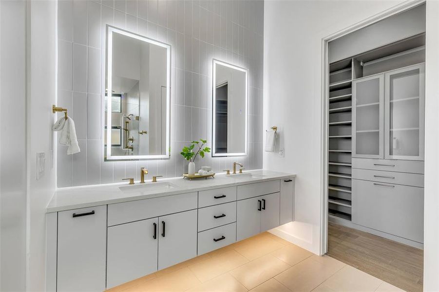 Dual vanities in the primary bathroom, enhanced by LED mirrors and ample storage, making your morning routine a breeze.