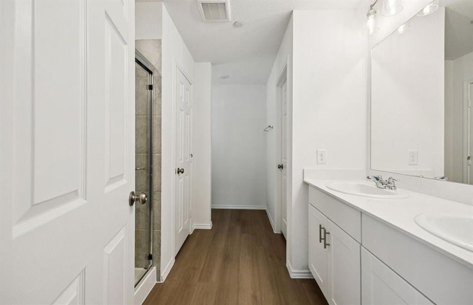 Owner's bath with double vanity and spacious shower *Real home pictured Owner's bath with double vanity and spacious shower *Real home pictured