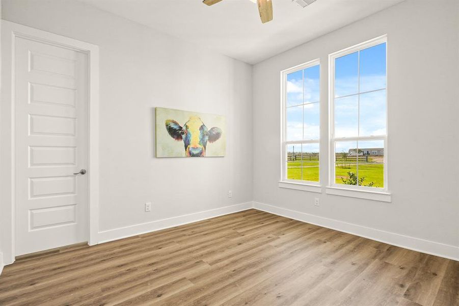 The Study, located behind a door off the Foyer, boasts LVP flooring, tall ceilings, ceiling fan, and two windows overlooking the spacious Front Yard. This space can also function as a fourth Bedroom, as it has a large walk-in closet and access to the Secondary Bathroom across the hall.