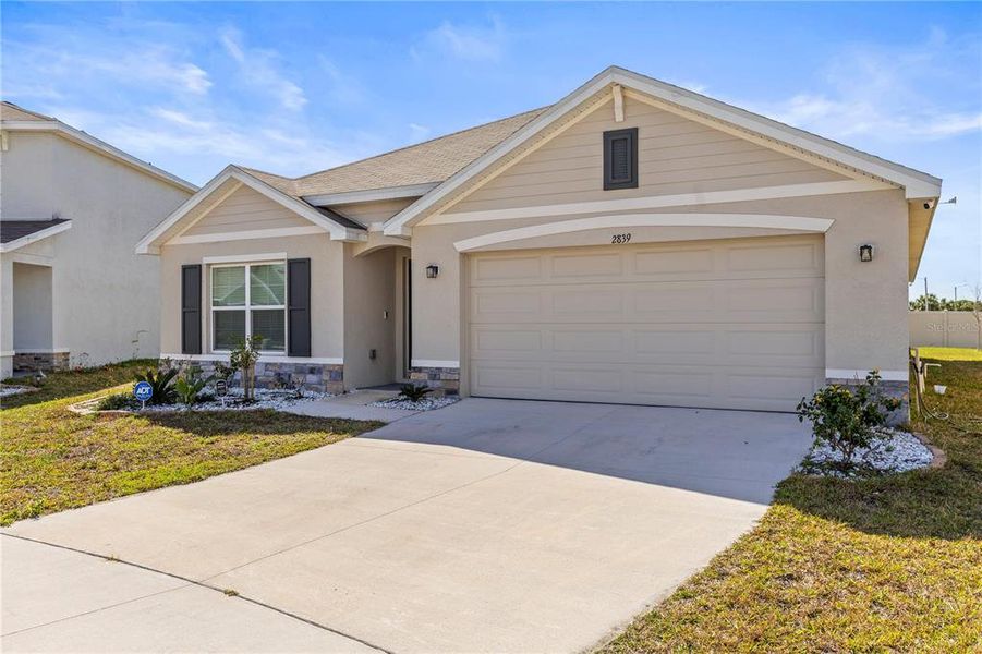 Front exterior of a new home in Berry Bay, Wimauma, FL, highlighting curb appeal (Image 18). Front exterior of a new home in Berry Bay, Wimauma, FL, highlighting curb appeal (Image 18).