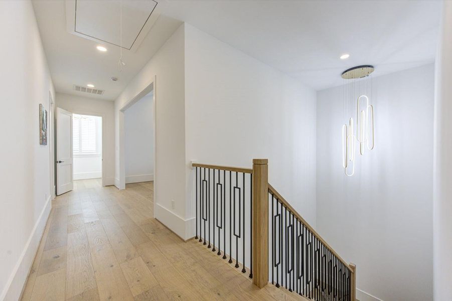 Wide hallway and ultra modern stairs. Large storage with built-in shelving in the attic.