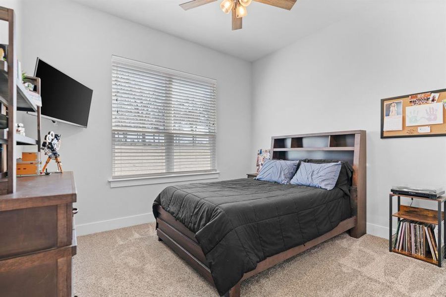 Bedroom featuring ceiling fan and carpet flooring