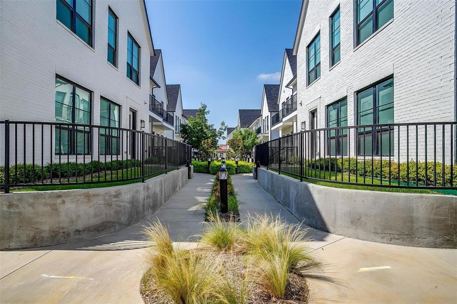 Paved walkways meander through the space, leading to cozy seating areas and shaded spots perfect for relaxation.