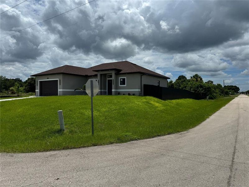 Front exterior of a new home in , Lehigh Acres, FL, highlighting curb appeal (Image 19).
