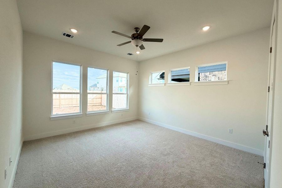 Well-lit and inviting, this generously proportioned primary bedroom awaits your personal touch. Well-lit and inviting, this generously proportioned primary bedroom awaits your personal touch.