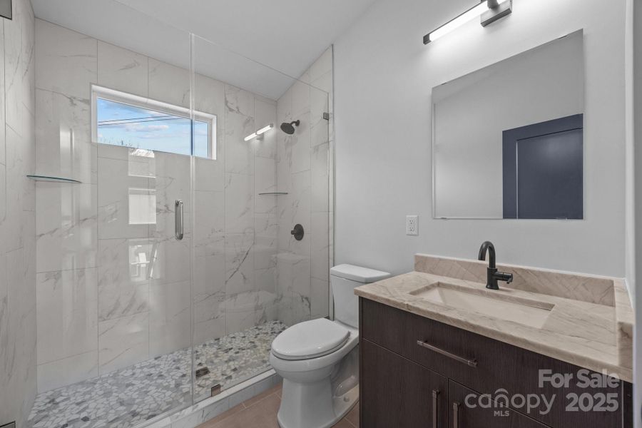 Full hall bath with custom tile shower