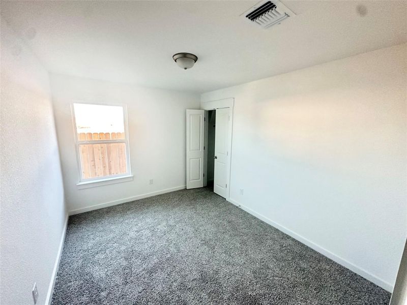 Unfurnished bedroom featuring carpet floors and baseboards