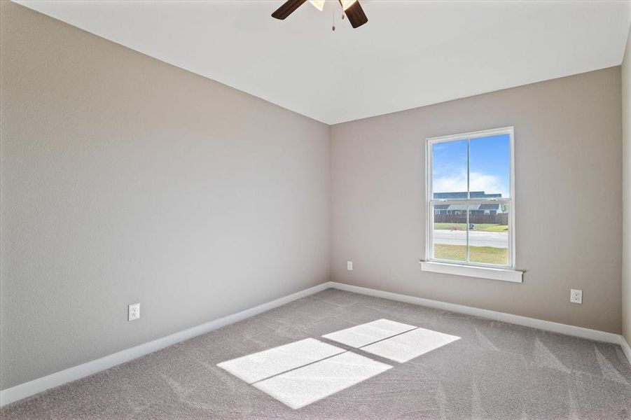 Bedroom with light carpet and ceiling fan