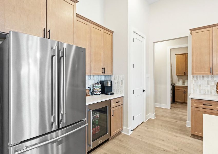 The kitchen has a double door refridgerator with a freezer drawer.