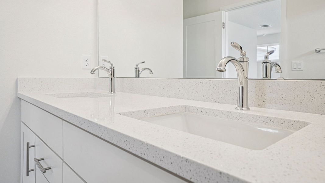 Plumeria Floor Plan primary suite bathroom with dual sinks by DRB Homes in Trailside located in Mount Dora, FL Plumeria Floor Plan primary suite bathroom with dual sinks by DRB Homes in Trailside located in Mount Dora, FL