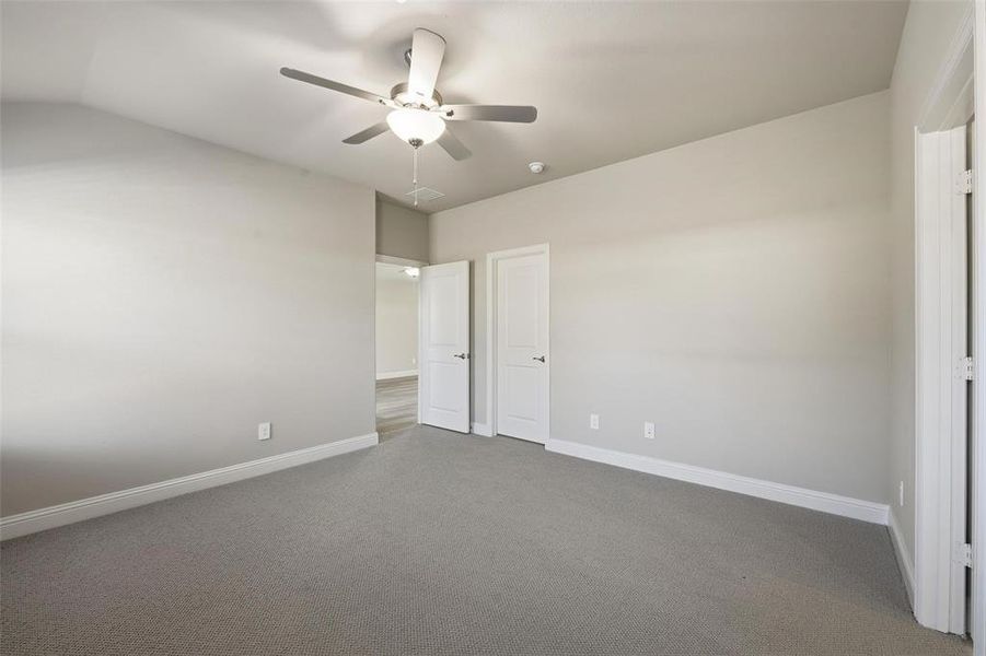 Unfurnished bedroom featuring carpet flooring and a ceiling fan