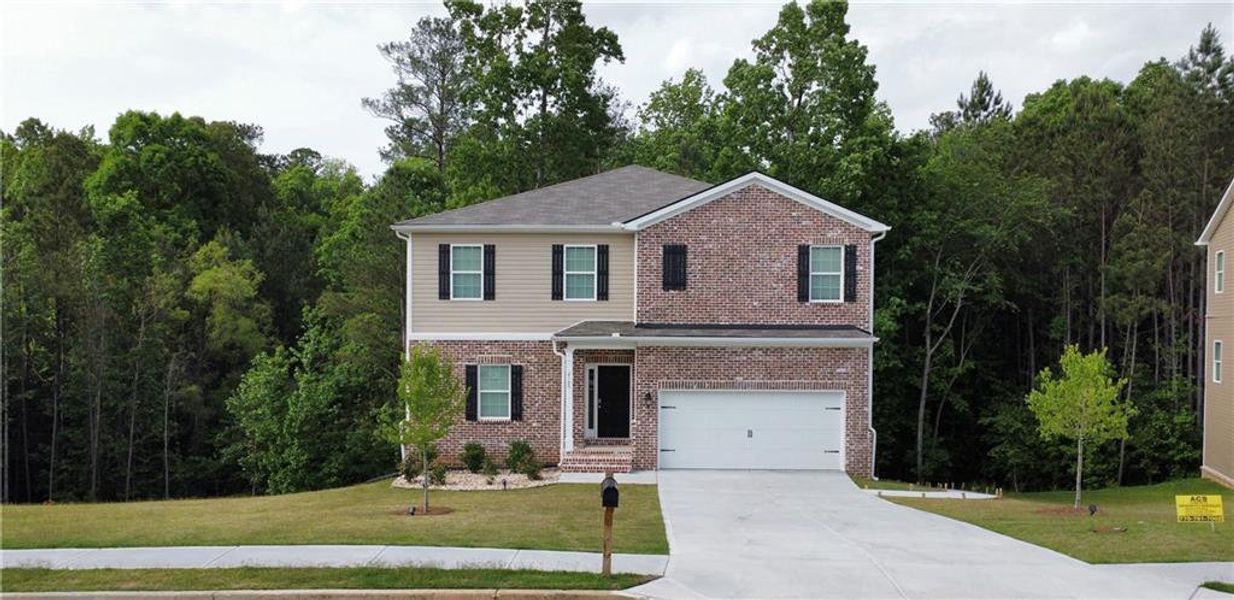 Front exterior of a new home in , Conyers, GA, highlighting curb appeal (Image 1).