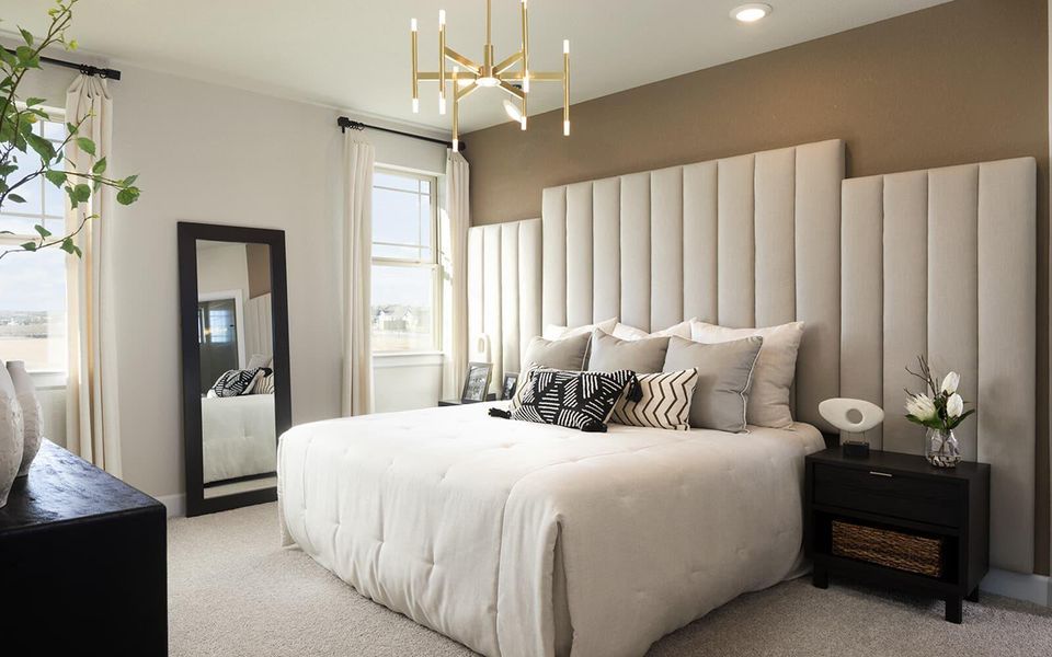 Bedroom featuring a chandelier and light colored carpet Bedroom featuring a chandelier and light colored carpet