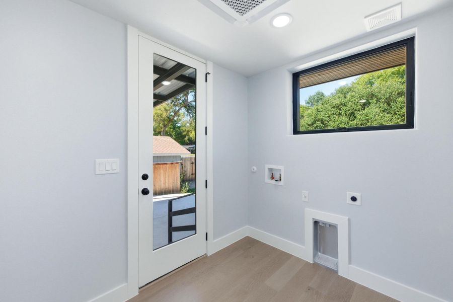 Washroom with light wood-style flooring, electric dryer hookup, recessed lighting, hookup for a gas dryer, and hookup for a washing machine Washroom with light wood-style flooring, electric dryer hookup, recessed lighting, hookup for a gas dryer, and hookup for a washing machine