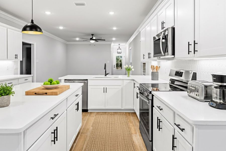 Front exterior of a new home in Crescent and Symphony at Hammock Bay, Freeport, FL, highlighting curb appeal (Image 2). Front exterior of a new home in Crescent and Symphony at Hammock Bay, Freeport, FL, highlighting curb appeal (Image 2).