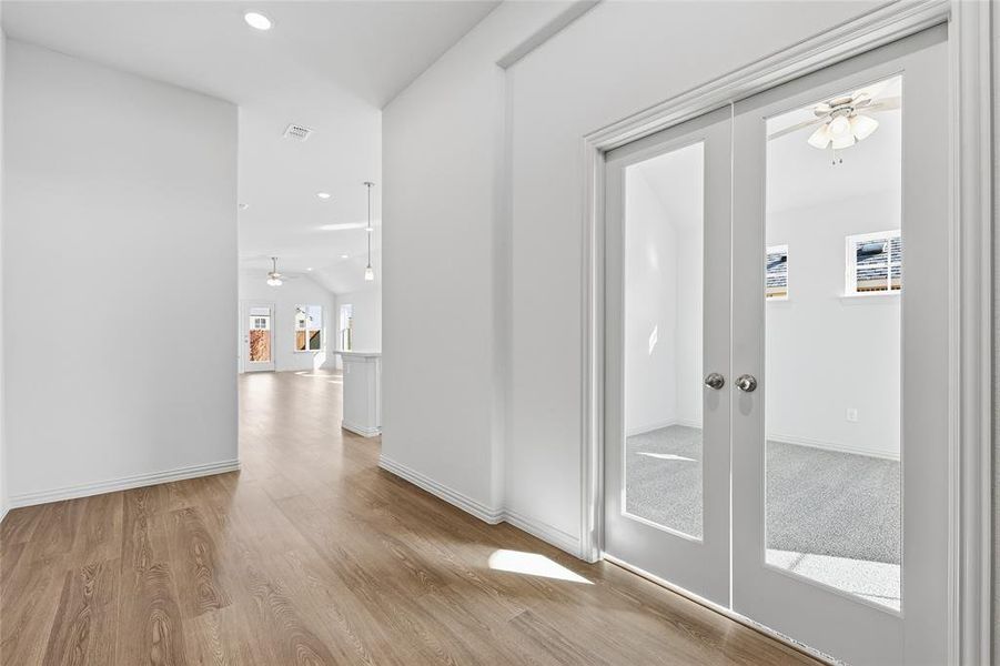 Hall featuring french doors, recessed lighting, and light wood finished floors