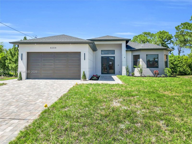 Front exterior of a new home in , Lehigh Acres, FL, highlighting curb appeal (Image 24).