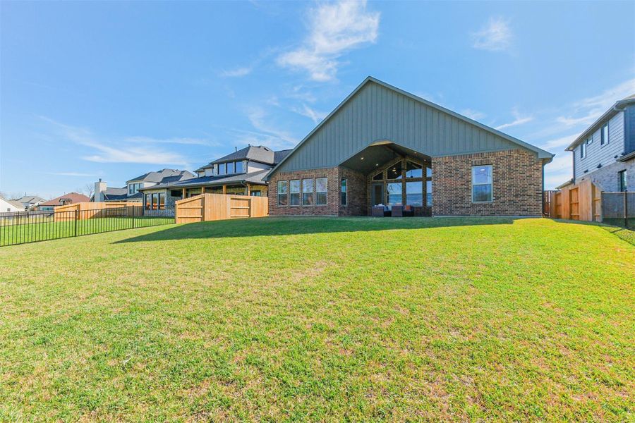 Side and rear exterior highlighting the spacious lot and private backyard.