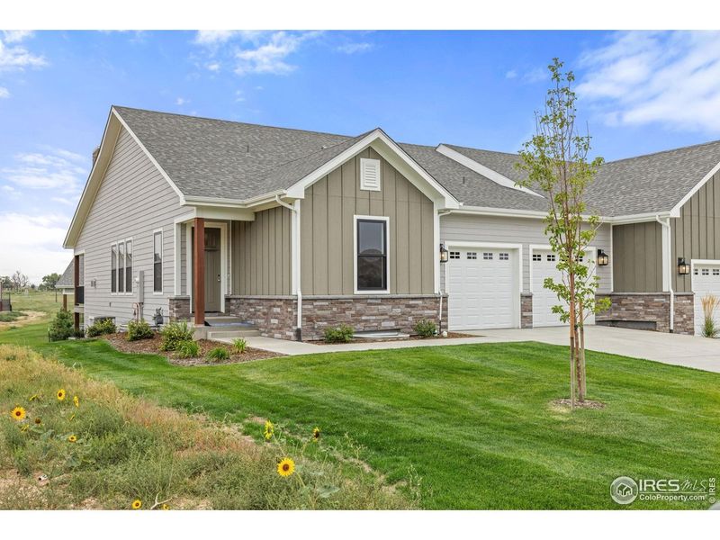 Front exterior of a new home in Cottages at Kelly Farm, Greeley, CO, highlighting curb appeal (Image 23).
