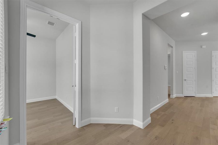 Corridor featuring light wood-style floors and recessed lighting