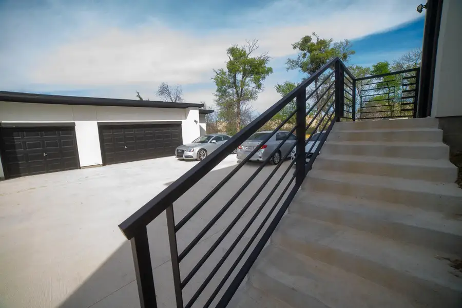 Ideally designed for modern living, a private side entrance provides a seamless transition from the three-car detached garage into a spacious mudroom. This dedicated arrival zone is perfect for keeping the main living areas clutter-free, offering a functional 'drop zone' for coats, bags, and shoes