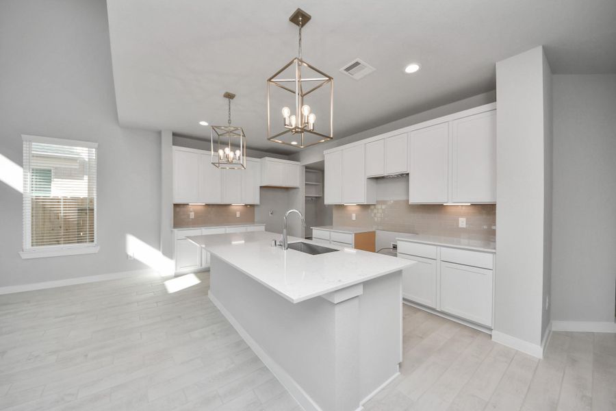 This generously spacious kitchen is a dream realized! Sample photo of completed home with similar floor plan. Actual colors and selections may vary. This generously spacious kitchen is a dream realized! Sample photo of completed home with similar floor plan. Actual colors and selections may vary.