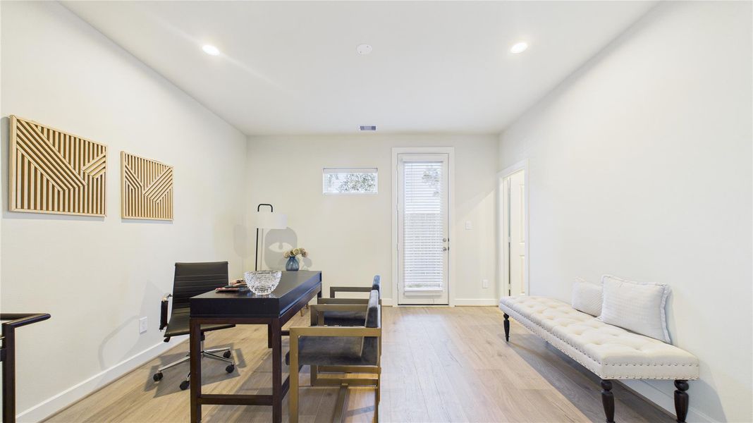 First floor bedroom with ensuite bath and walk-in closet. Door to back patio. Here, used as a n office. First floor bedroom with ensuite bath and walk-in closet. Door to back patio. Here, used as a n office.