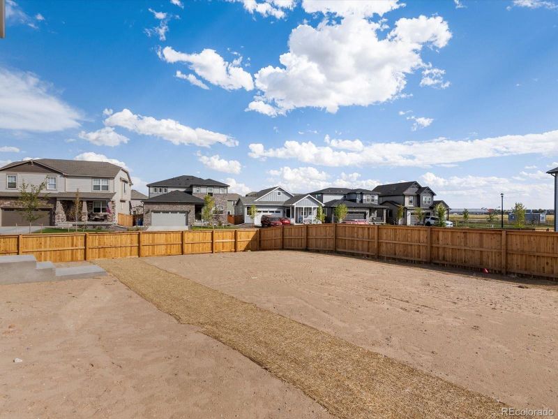 Front exterior of a new home in Ridgeline Vista: The Flora Collection, Brighton, CO, highlighting curb appeal (Image 21). Front exterior of a new home in Ridgeline Vista: The Flora Collection, Brighton, CO, highlighting curb appeal (Image 21).