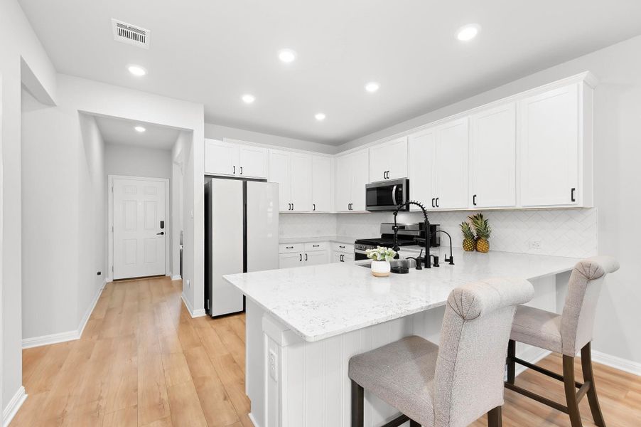 Gorgeous kitchen with a breakfast bar and stainless steel appliances Gorgeous kitchen with a breakfast bar and stainless steel appliances