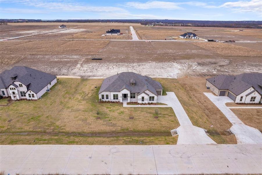 Front exterior of a new home in , Waxahachie, TX, highlighting curb appeal (Image 9).