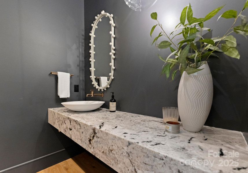 Powder room on the main level, complete with a gorgeous leathered granite in floating countertop. Powder room on the main level, complete with a gorgeous leathered granite in floating countertop.