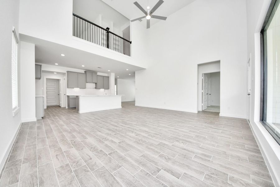Relax and unwind in this inviting family room, illuminated by abundant natural light streaming in through tall windows, complemented by high ceilings and stunning flooring. Stay comfortable year-round with the gentle breeze from the ceiling fan, creating the perfect atmosphere for family gatherings. Relax and unwind in this inviting family room, illuminated by abundant natural light streaming in through tall windows, complemented by high ceilings and stunning flooring. Stay comfortable year-round with the gentle breeze from the ceiling fan, creating the perfect atmosphere for family gatherings.
