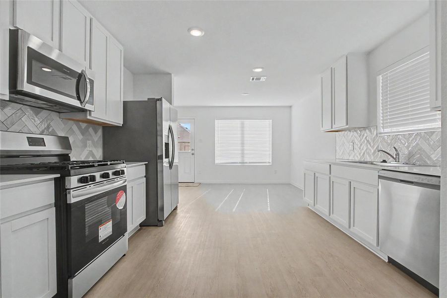 Furnished interior view inside a new home in Sunterra, Katy (Image 6).