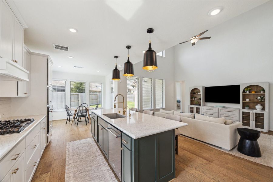 An additional view of the kitchen highlights the cozy breakfast nook tucked into the corner, along with easy access to the backyard and a seamless connection to the family room.