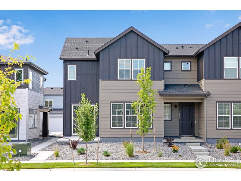 Front exterior of a new home in Westside Crossing Townhomes, Berthoud, CO, highlighting curb appeal (Image 2).