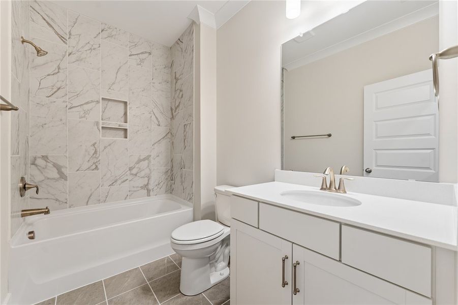 A refined bath with a sleek white vanity and a sho