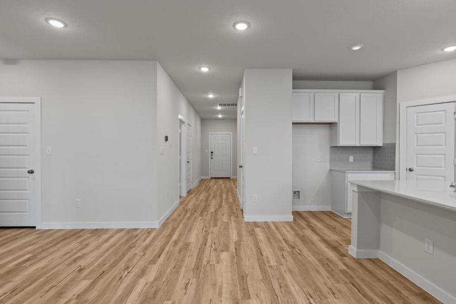 A large empty room with white cabinets. A large empty room with white cabinets.