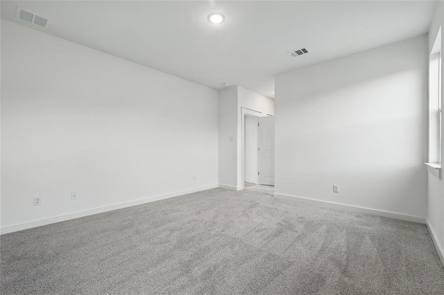 Carpeted empty room with baseboards