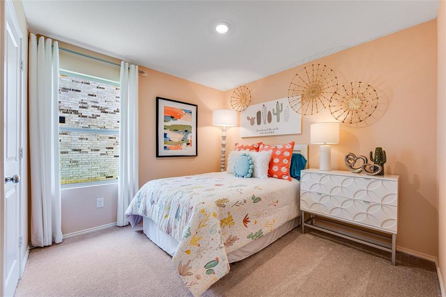 Bedroom featuring light carpet