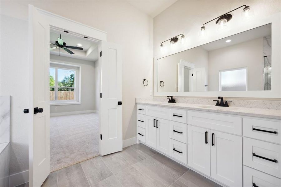 Bathroom with ceiling fan and vanity