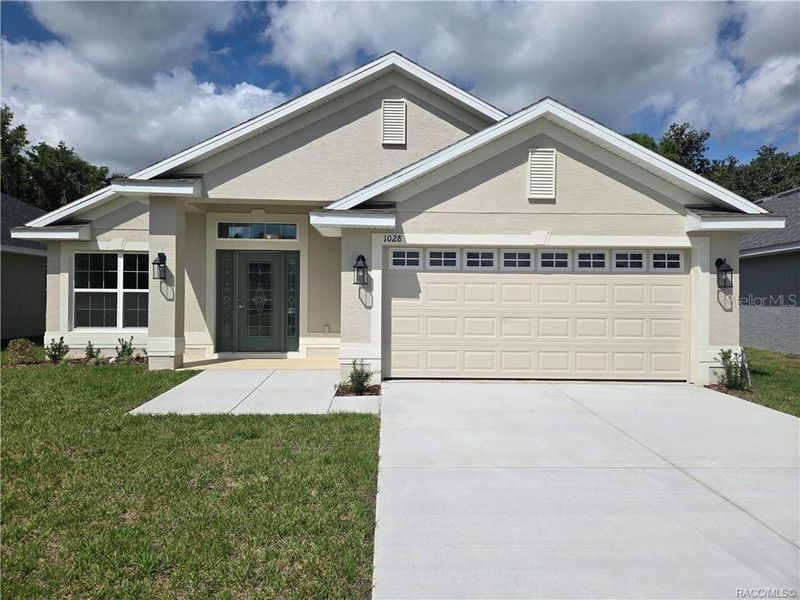 Front exterior of a new home in Wyld Palms, Inverness, FL, highlighting curb appeal (Image 21).